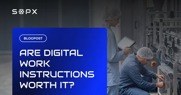 Two workers in a manufacturing facility reviewing digital work instructions on a tablet, illustrating the ROI of digital work instructions.