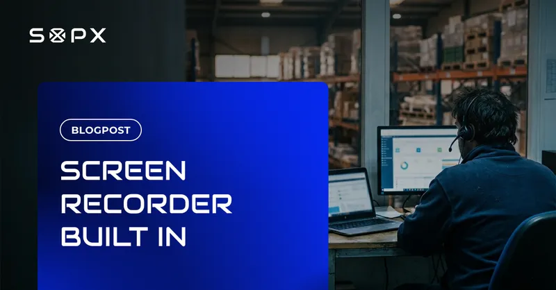 A warehouse team lead wearing a headset, recording a software process on a desktop monitor in an office overlooking the warehouse floor.